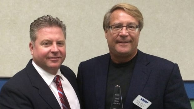 Ron Bailey (right), vice president of sales and marketing at Turning Point Propellers, receives the 2015 Mel Barr Award from Rob Gueterman, incoming president of the National Marine Representatives Association.