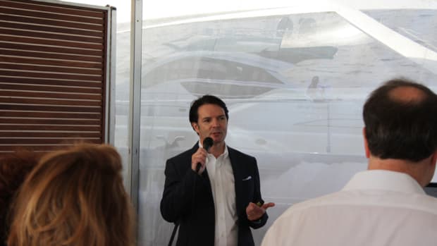 Ferretti Group Americas President and CEO James Henderson addresses a press gathering Thursday morning at the group’s display along Collins Avenue.