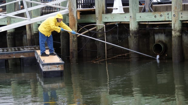 A marina employee performs storm water runoff testing in response to a reminder issued by software developed by environmental consultant Ted Sailer