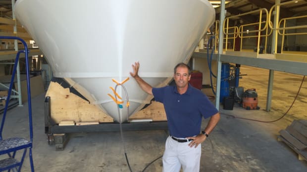 Bertram Yachts CEO Peter Truslow is shown with hull No. 3 of the Bertram 35, which is being assembled and completed at the new Tampa facility.