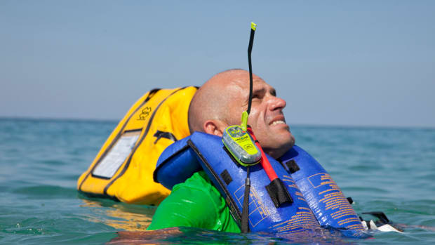 A boater is shown wearing an emergency beacon from ACR Electronics. ACR is supporting the new program by donating eight beacons.