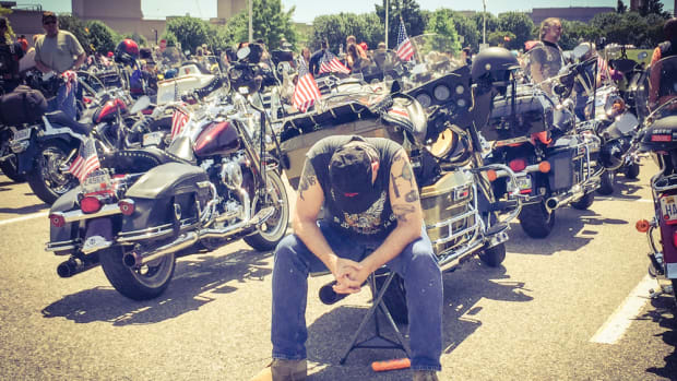 A young soldier is deep in thought before leaving from a Pentagon parking lot with other riders during the Rolling Thunder XXVIII First Amendment Demonstration Run on Sunday.