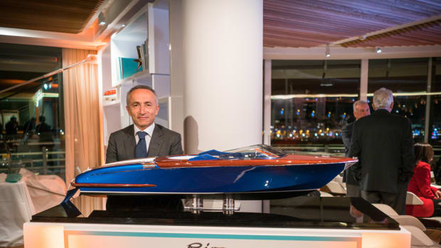 Ferretti Group CEO Alberto Galassi is shown with a model of the Aquariva Super that the group auctioned to raise money to support earthquake relief efforts in Italy.