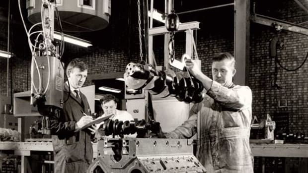 Cummins Darlington employees are shown at work on a Small Vee engine during the 1960s.
