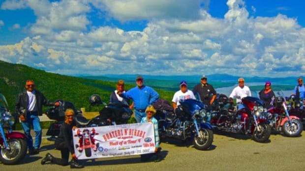 Tour riders stopped Sunday at the Height of Land observation station on top of Spruce Mountain in Rangeley, Maine.