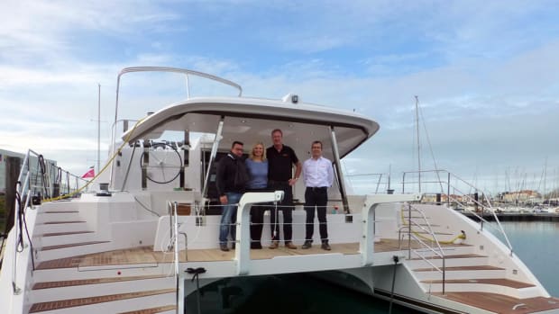 Privilege Marine CEO Gilles Wagner (left) is shown with the future owners of the first Privilege Series 5 Hybrid Catamaran and Torqeedo's Ulf Kanne (right).