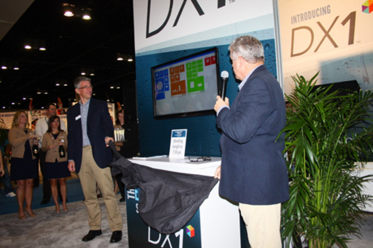 Dominion Marine Media vice president of technology Damir Tresnjo (left) and senior vice president Ian Atkins present the new DX1 software system to dealers on Monday night.