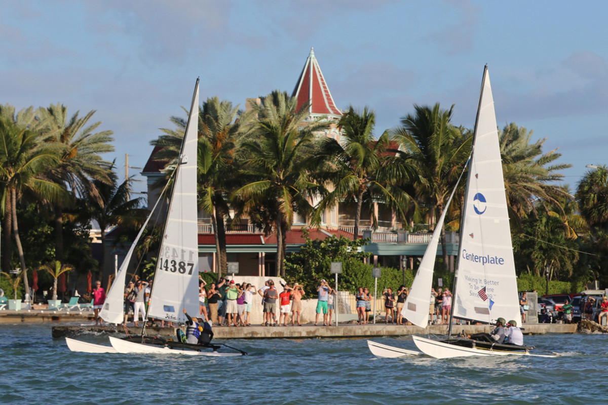 Crews aboard two16-foot-long Hobie Cat sailboats sail past the Southernmost House in Key West, Fla., Saturday, May 16, 2015, just after the start of a more than 90-mile race to Havana, Cuba. The Havana Challenge is believed to be the first U.S. government-sanctioned sailing race between Key West and Cuba in more than 50 years. Five Hobie Cats are participating in the event. FOR EDITORIAL USE ONLY (Rob O'Neal/Florida Keys News Bureau/HO)