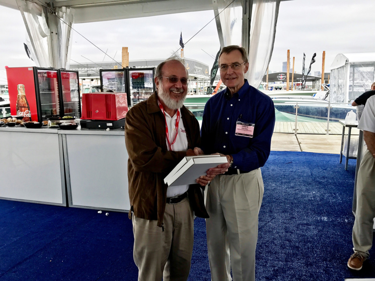 Jim Flannery, of Soundings and Anglers Journal — both Active Interest Media publications — captured four awards at the Boating Writers International writing awards competition today. Flannery (left) is shown accepting one of the prizes from BWI executive director Greg Proteau.