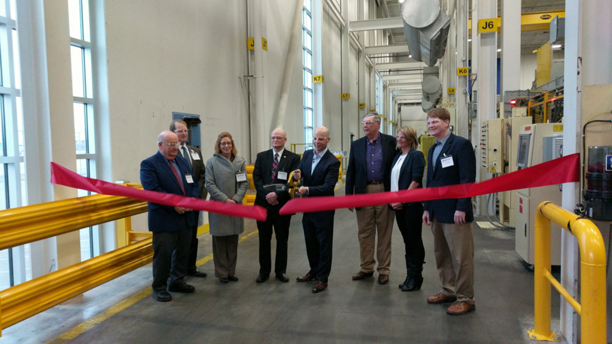 Mercury Marine president John Pfeifer cuts the ribbon for the commissioning of a 4,500-ton Buhler-Prince die-casting machine at the company’s plant in Fond du Lac, Wis.