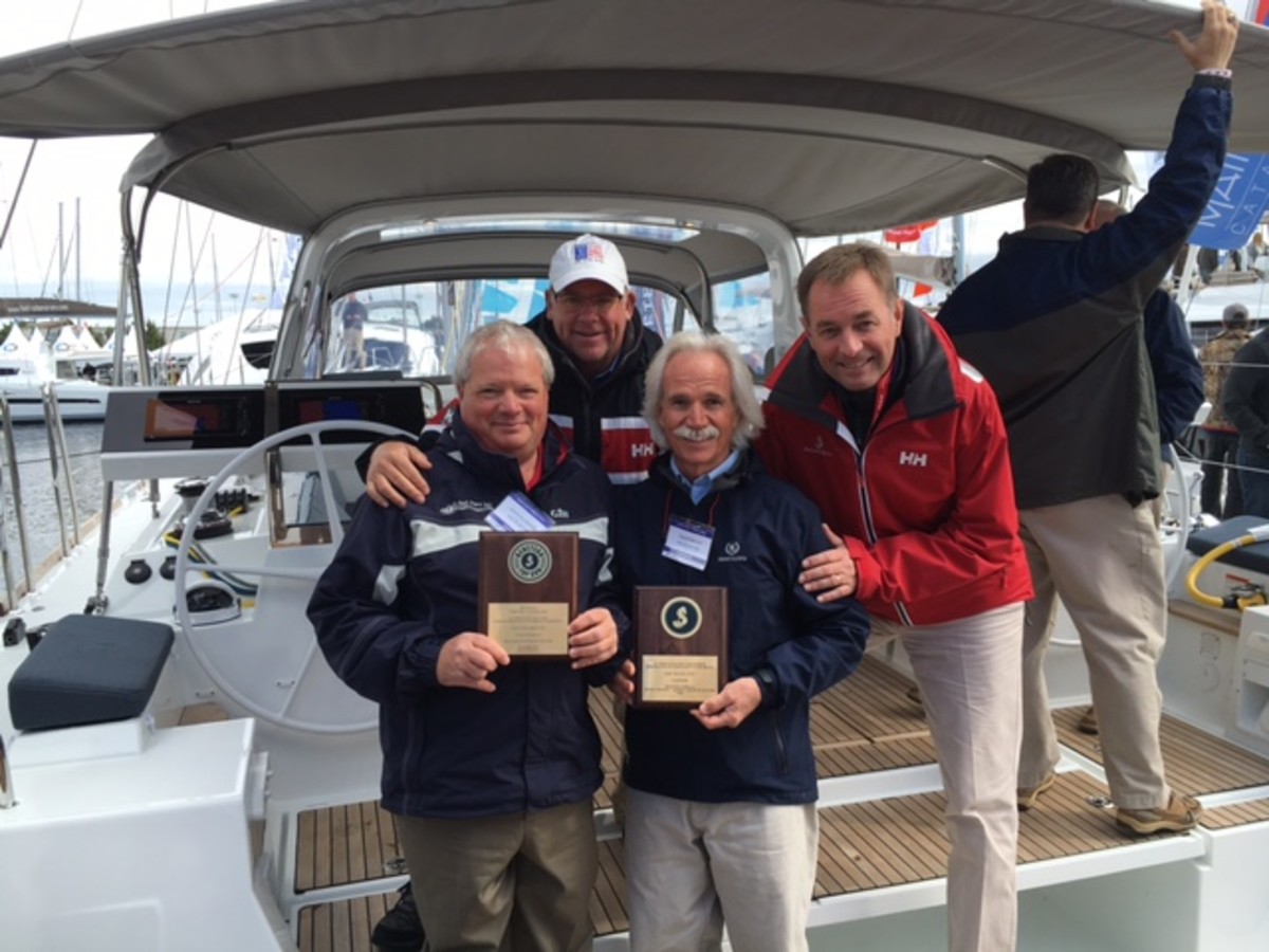 Shown are Beneteau U.S. sailboat sales manager Chris Doscher (rear, at left); Beneteau America president Laurent Fabre (rear, at right); Dave Fulbright, of Sail Place (front, at left); and Tim Fulbright, of Sail Place.