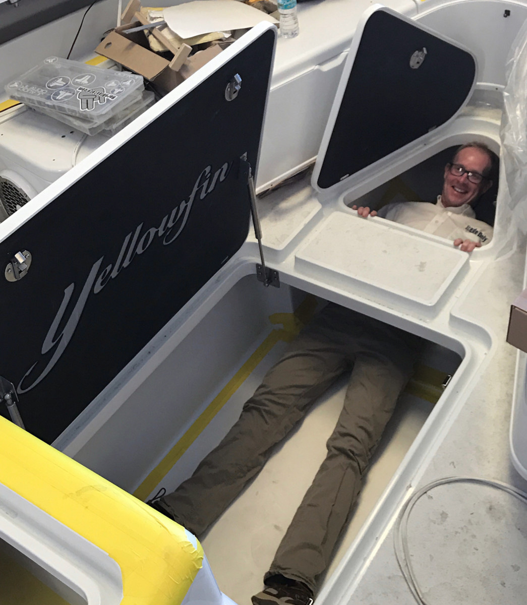 Turner’s boat has a custom foredeck fishbox to hold ice-immersed big tuna. Trade Only executive editor Chris Landry, who is 6 feet, 2 inches tall, shows just how big it is.