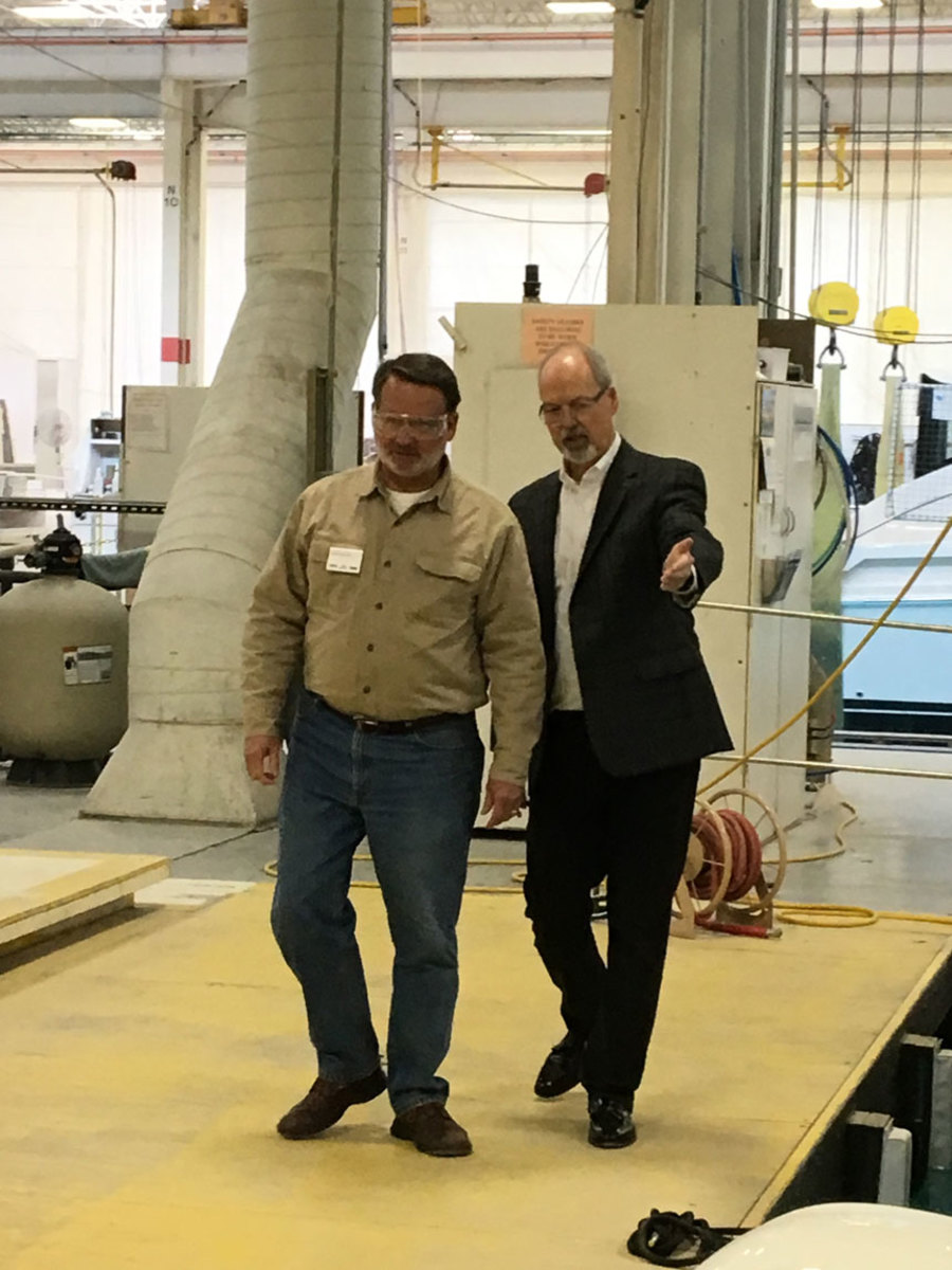   Sen Gary Peters (left) tours the Tiara Yachts factory in Holland, Mich., with David Slikkers.  