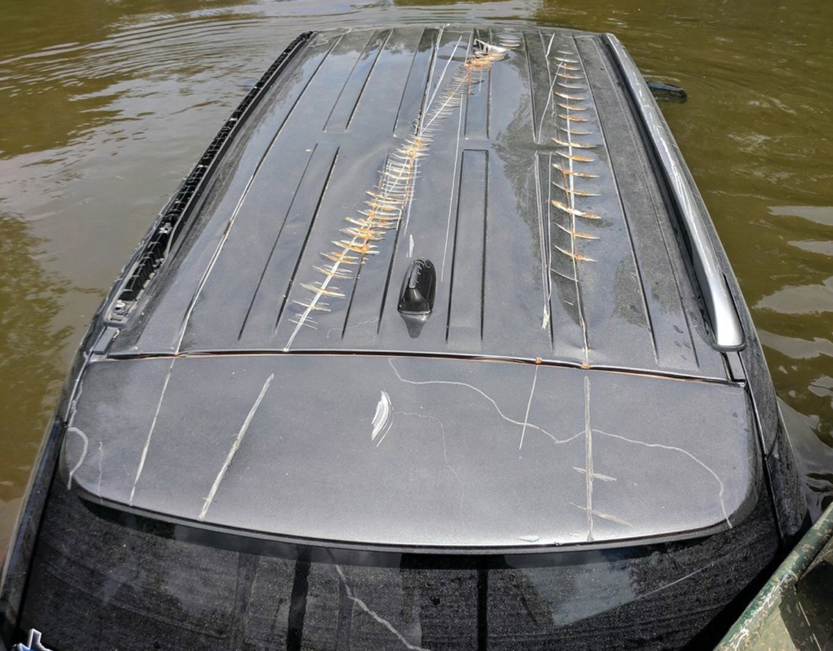 Prop marks show that this vehicle spent time underwater during the storm.