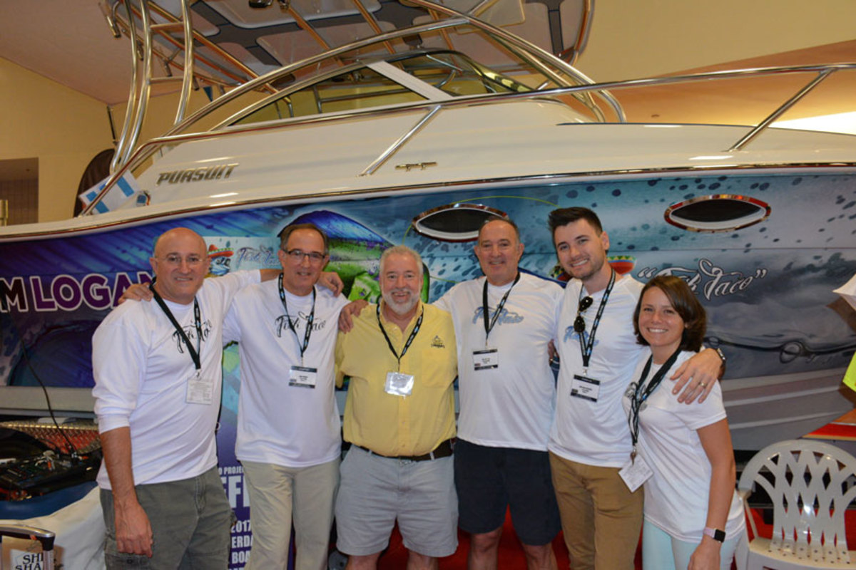 “Ship Shape TV” host John Greviskis (in yellow shirt) is shown with the team from the show that covered the makeover of the Pursuit 2650.