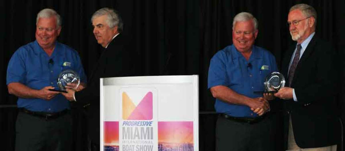 From left, NMMA president Thom Dammrich presents the Charles Chapman Award to Tom Marhevko and to Phil Cappel.   
