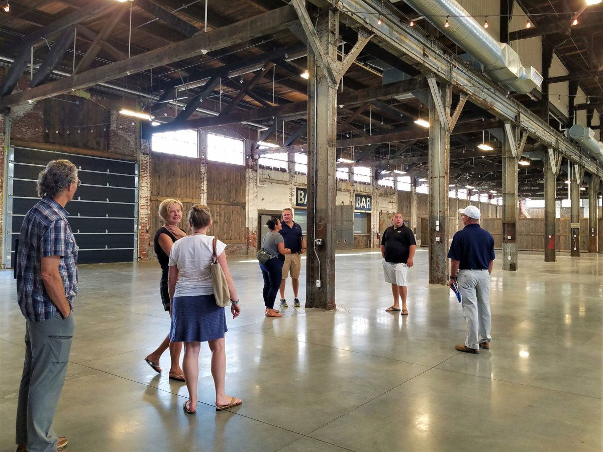 MMTA show committee viewing the event venue for The Maine Boat Show at Thompson’s Point — a converted historic brick building with polished floors and bar service.
