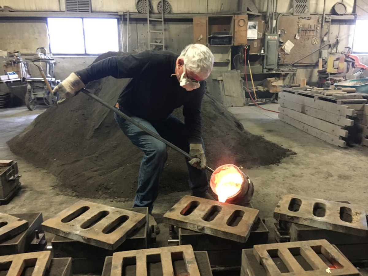 Mike Hood pours molten bronze for the final time of his 43-year career.