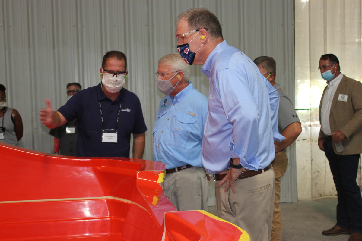 NauticStar Boats President Scott Womack shows Sen. Roger Wicker and Rep. Trent Kelly the mold preparation process.