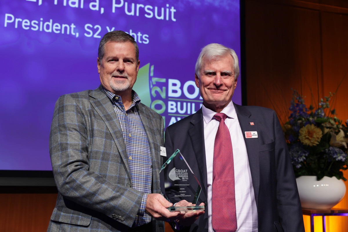Tiara Yachts president and CEO Tom Slikkers (left) accepted the Lifetime Achievement award on his father Leon’s behalf.