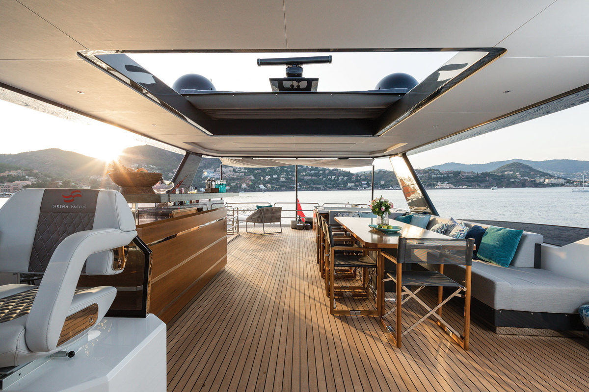 The flybridge on the 88 takes advantage of the boat’s 23-foot beam. There’s a hot tub aft and to port.