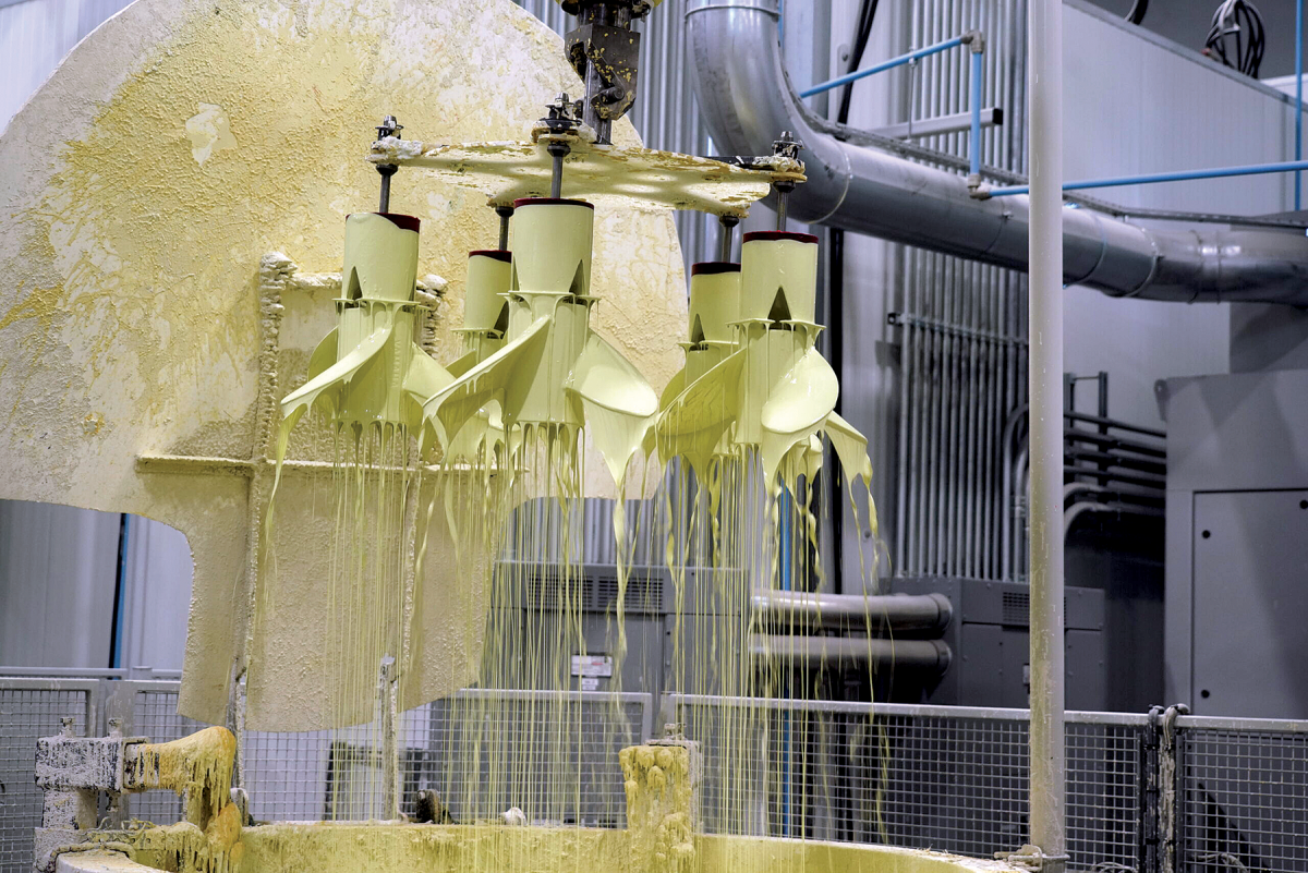 Robotic arms dip wax positives into ceramic slurries, and silica sand and zircon flour baths to form hard molds into which molten stainless steel will be poured.