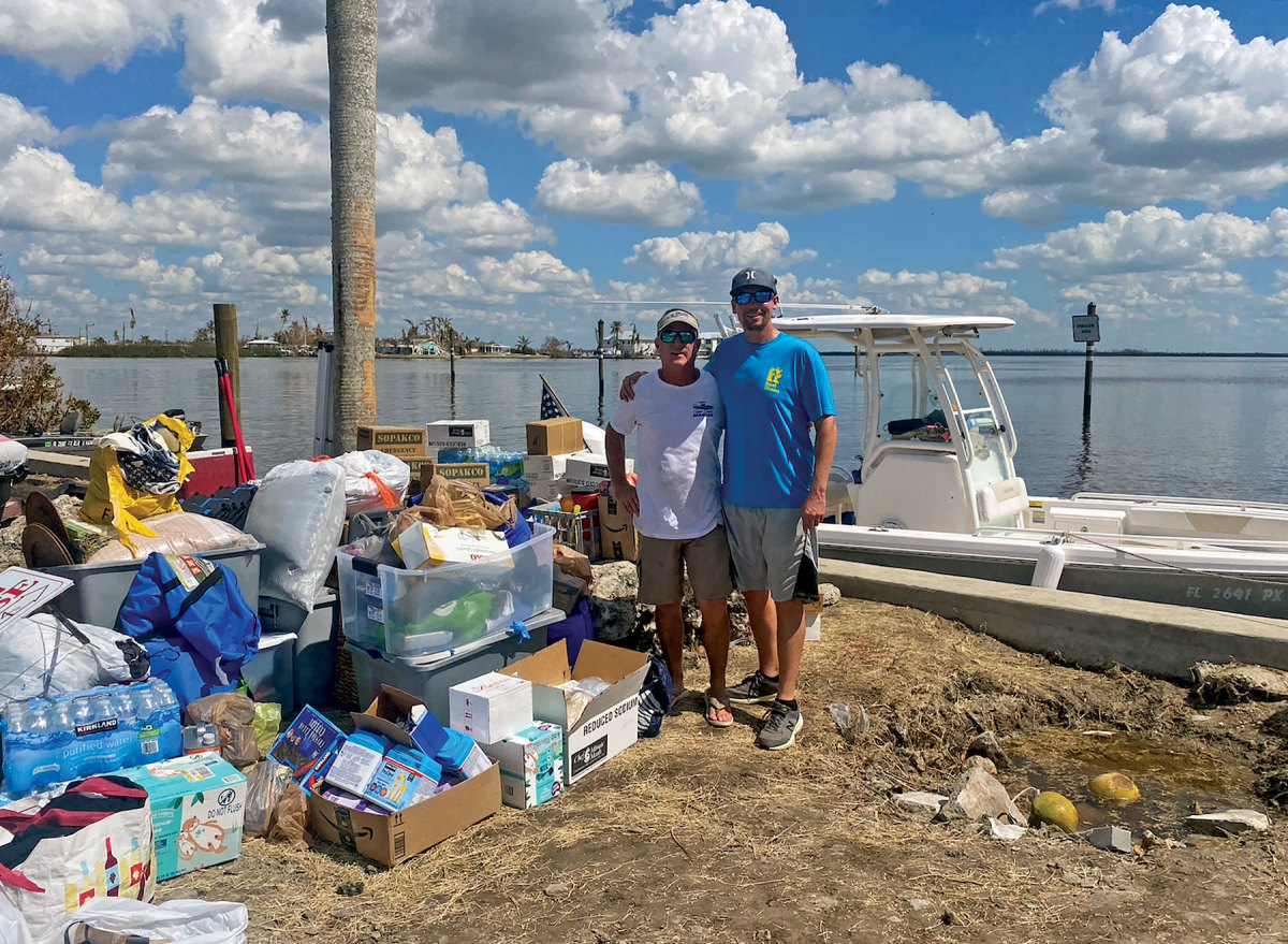Kyle Good (blue shirt) from the Southwest Florida Marine Industries Association brought much-needed supplies to Gary Cullen of Cape Coral Marine.